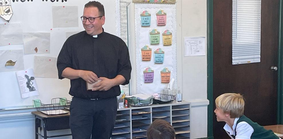 Faith formation - Priest instructing religion class at St. Stanislaus Catholic School in Modesto, Ca